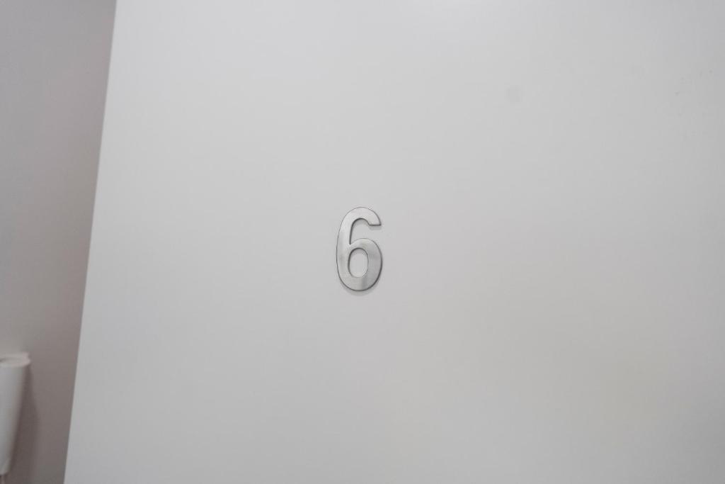 a white door with the number six on it at Prestige House 6 in Scalea