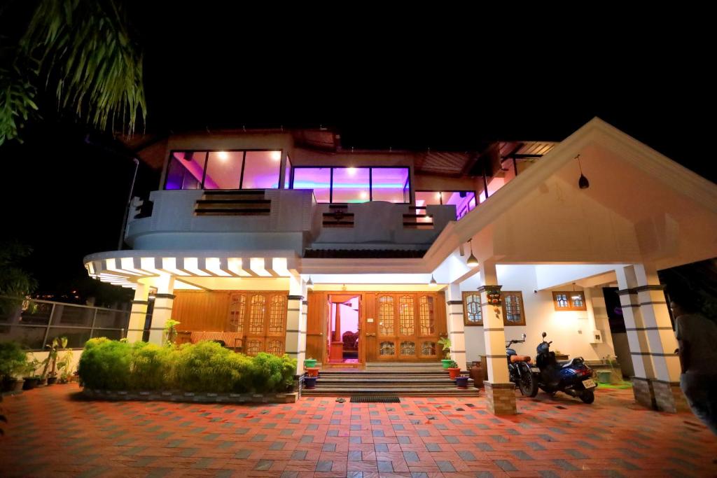a house with a motorcycle parked in front of it at Hillsidecreek Homestay in Anachal