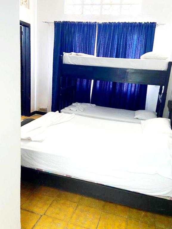 Postel nebo postele na pokoji v ubytování Hospedaje Carmelita Tocaima