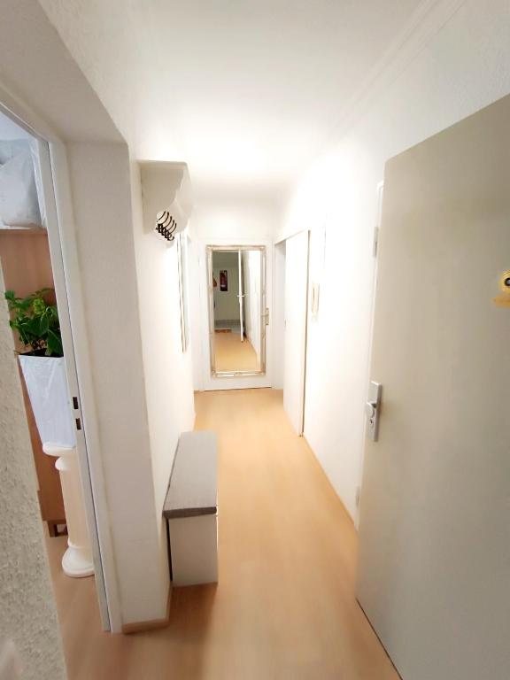 a hallway of an apartment with a table and a door at Ferienwohnung-Montagewohnung 3 in Bad Driburg