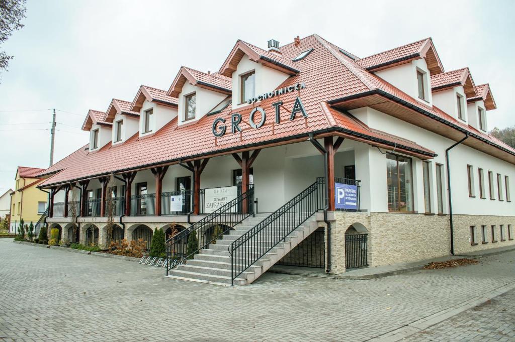 a building with a staircase in front of it at Grota Bochotnicka in Kazimierz Dolny