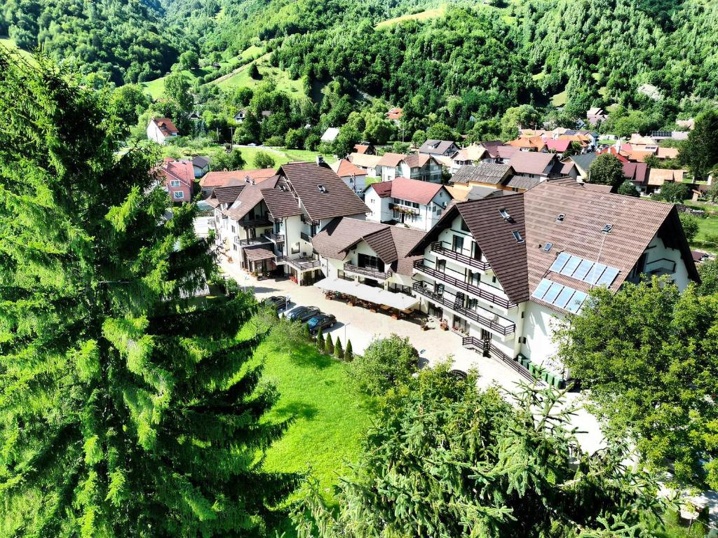 an aerial view of a house in a mountain at Pensiunea Andrei Moieciu in Moieciu de Jos
