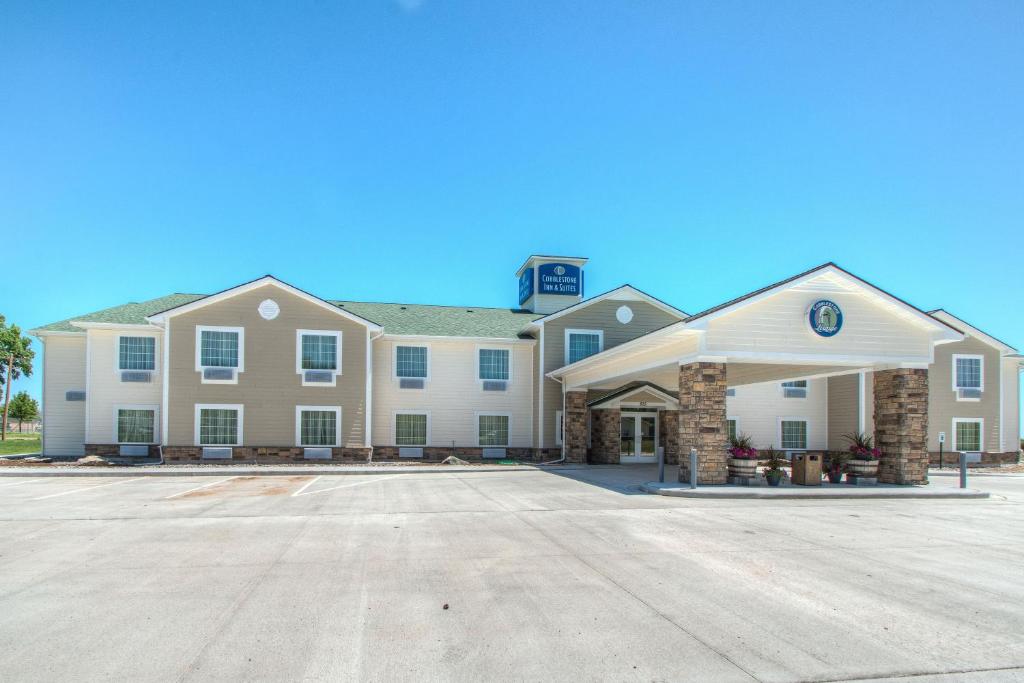 a large building with a parking lot in front of it at Cobblestone Inn & Suites - Holyoke in Holyoke