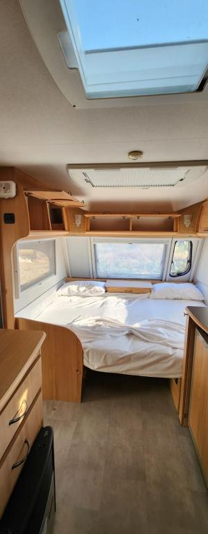 a small bedroom in an rv with a bed at Hana Land in Qeparo