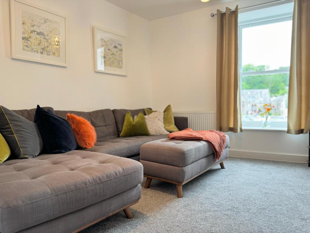 a living room with a couch and a ottoman at The Courtyard, 4 - Bed, Sleeps 6, Pets Welcome in Ulverston