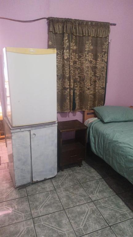 Postel nebo postele na pokoji v ubytování Hospedaje Barato Mi Casita de Colores