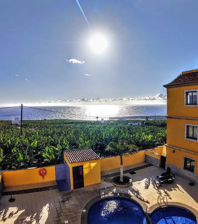 a hotel with a view of the ocean and a building at La Pura Vida in Tazacorte