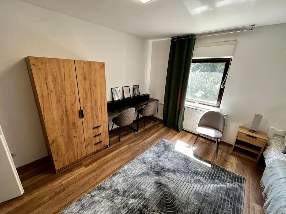 a living room with a bed and a wooden door at Charming flat in Maribor