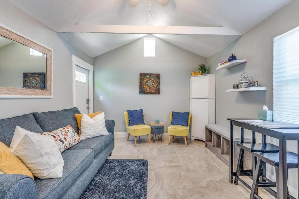 a living room with a couch and a table and chairs at Cozy Comfy Studio with full sofa bed and kitchenette in West Palm Beach