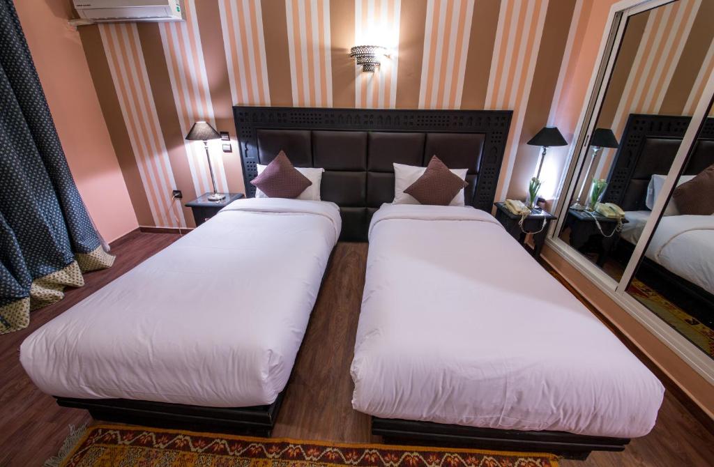 Postel nebo postele na pokoji v ubytování Hotel Akouas