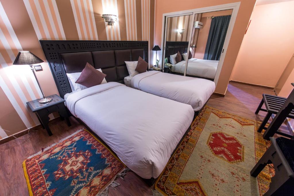 Postel nebo postele na pokoji v ubytování Hotel Akouas