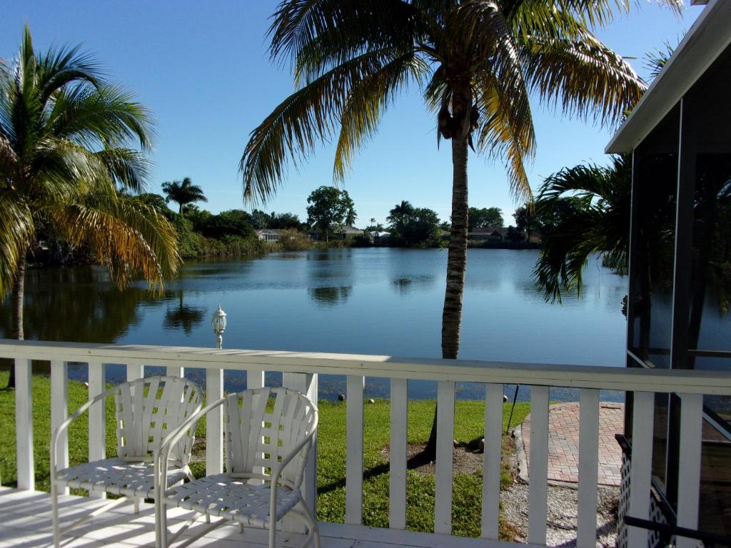 a porch with two chairs and a view of a river at Marco Island Lakeside Inn in Marco Island