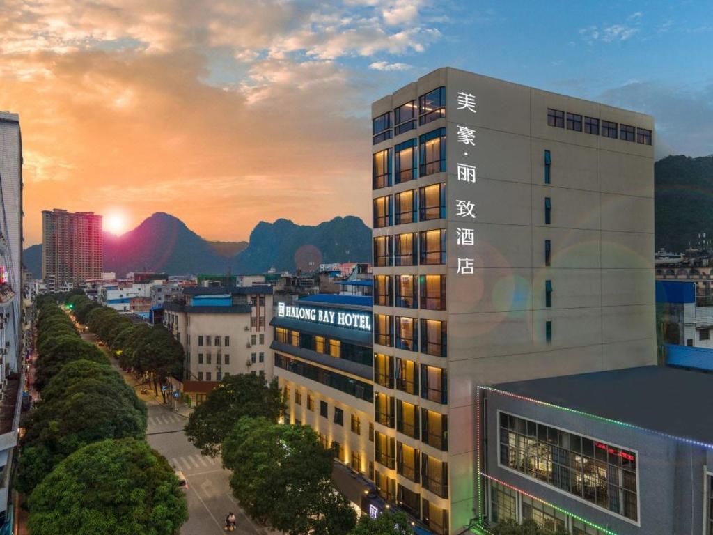 a building in a city with a sunset in the background at Mehood Lestie, Pingxiang Bus Station Food Street in Pingxiang
