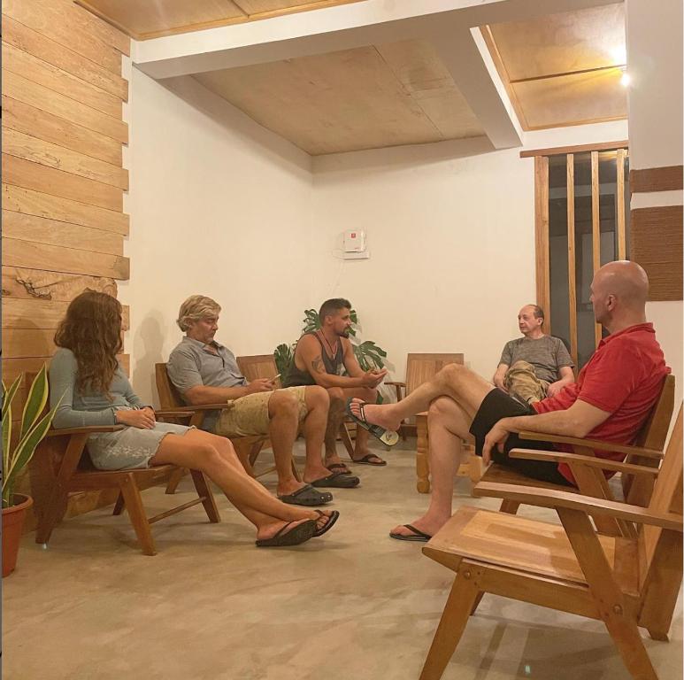 a group of people sitting in chairs in a room at Suffix Retreat - Stay, Dive & Explore Fuvahmulah in Fuvahmulah
