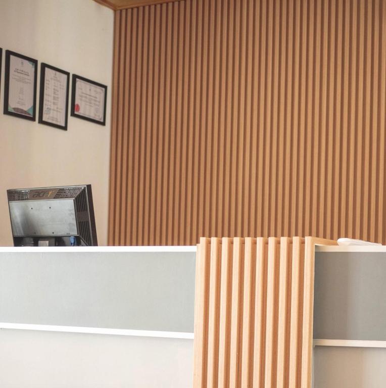 an office with a counter and a wall with stripes at Suffix Retreat - Stay, Dive & Explore Fuvahmulah in Fuvahmulah