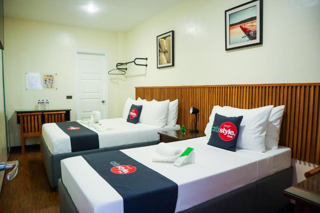 Postel nebo postele na pokoji v ubytování Citistyle Inn