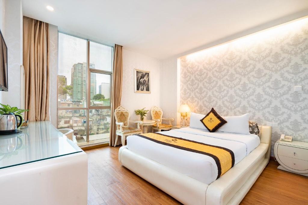 Postel nebo postele na pokoji v ubytování Golden Star Hotel