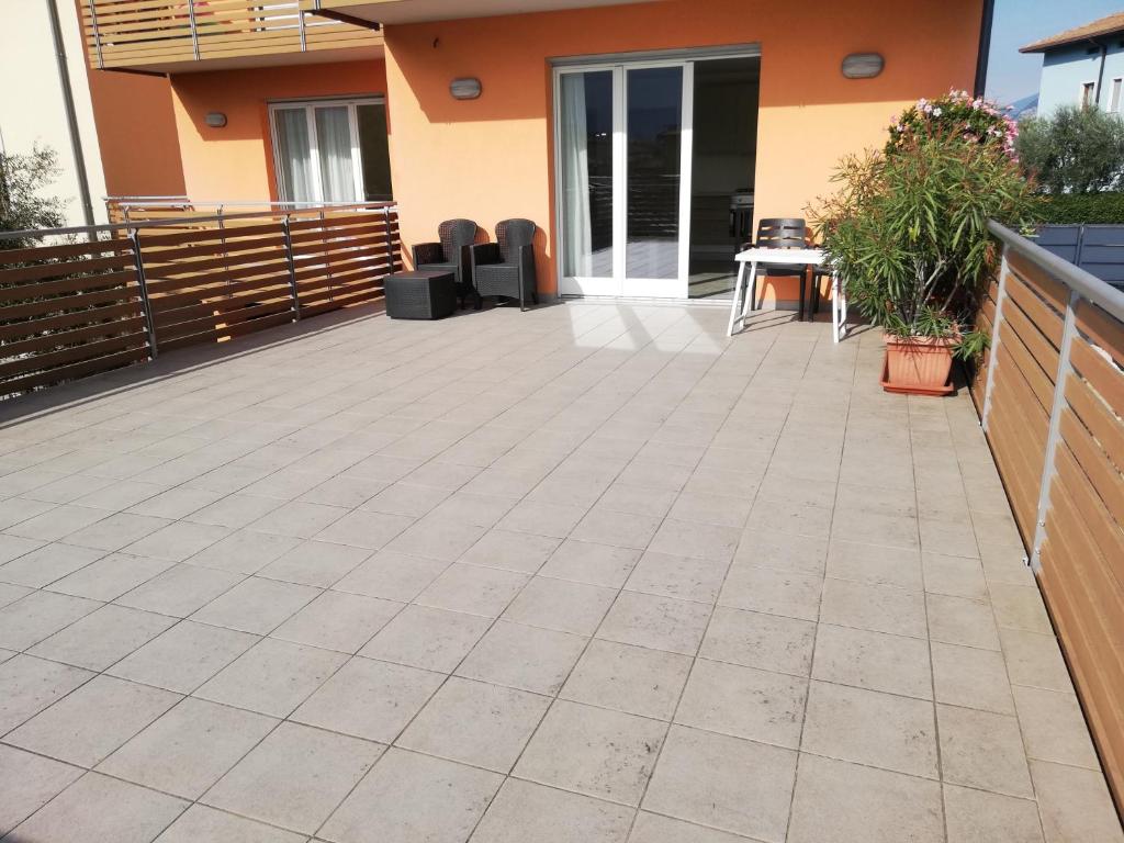 a patio outside of a house with a fence at Appartamento La Terrazza in Riva del Garda