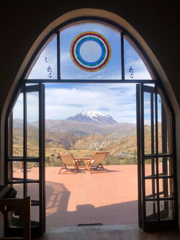 an open glass door with a view of a mountain at ALLKAMARI Eco-Resort&Spa in Uni