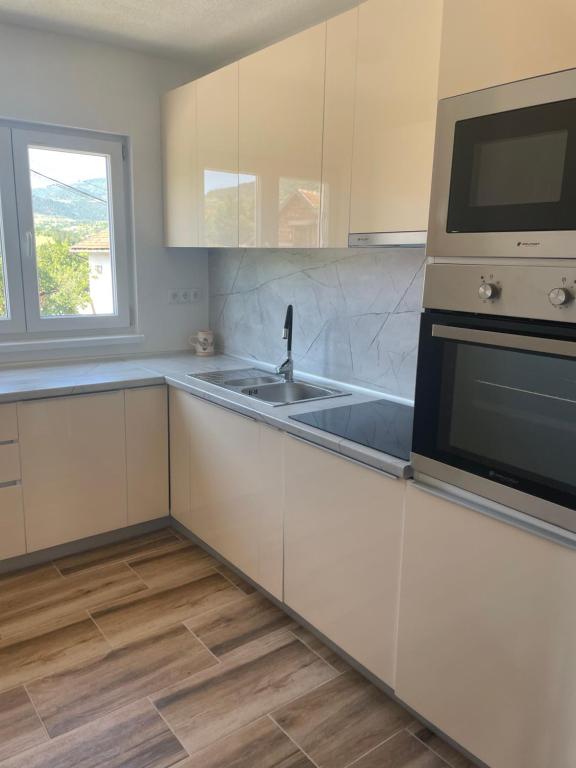 a kitchen with a sink and a microwave at Vidovdanska house in Šipovo