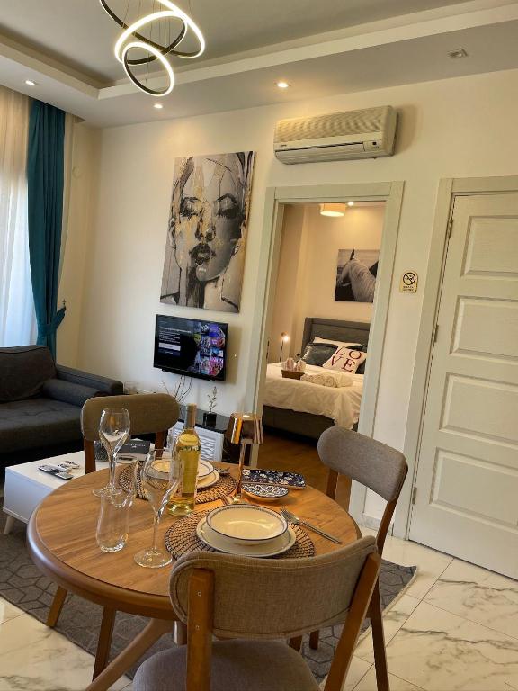 a living room with a table and a bedroom at kestel city 1 in Alanya