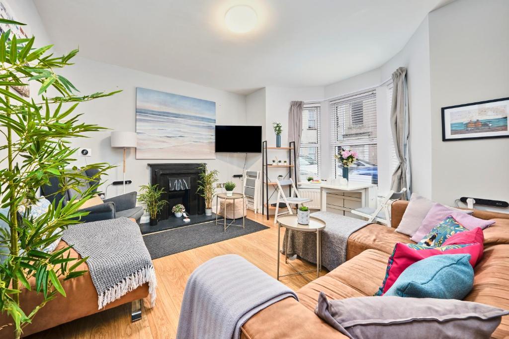 a living room with a couch and a fireplace at Princess Yellow 1 - Portrush by the Sea in Portrush