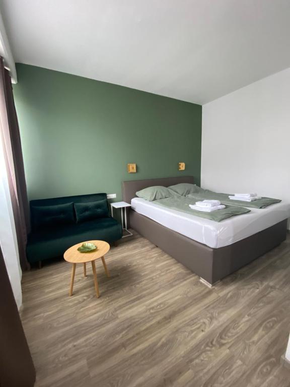a bedroom with a bed and a couch and a table at bookVienna "Paula" Apartments in Vienna