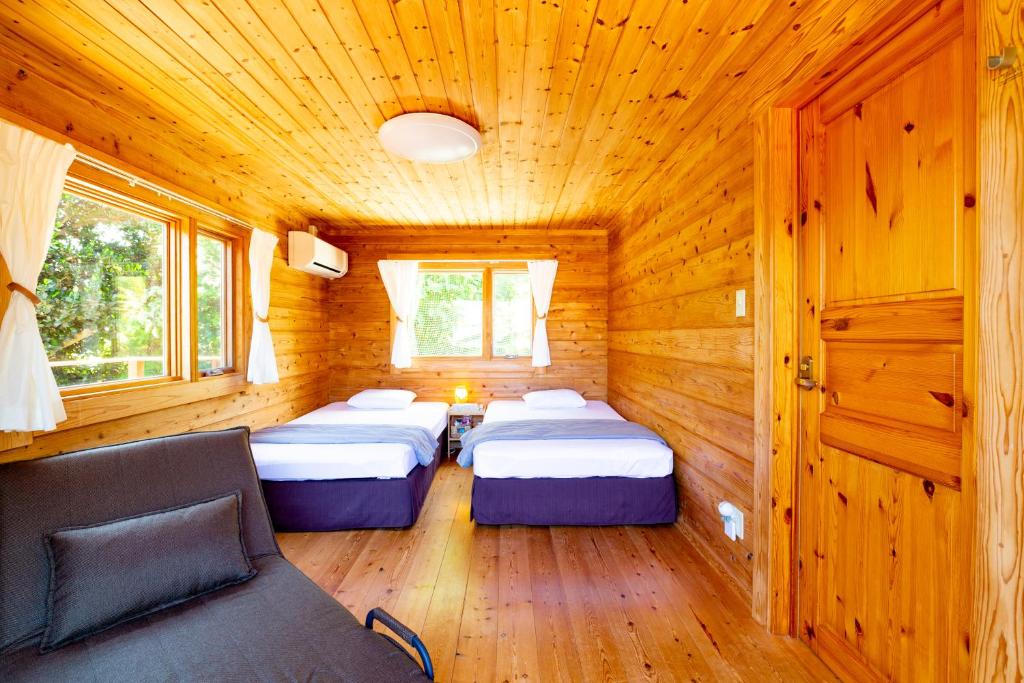 Postel nebo postele na pokoji v ubytování 石垣島コテージAkeeesi365 LOG