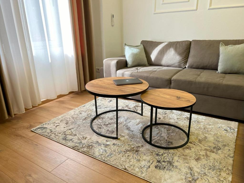a living room with a couch and two tables at Durres Vintage Apartment in Durrës