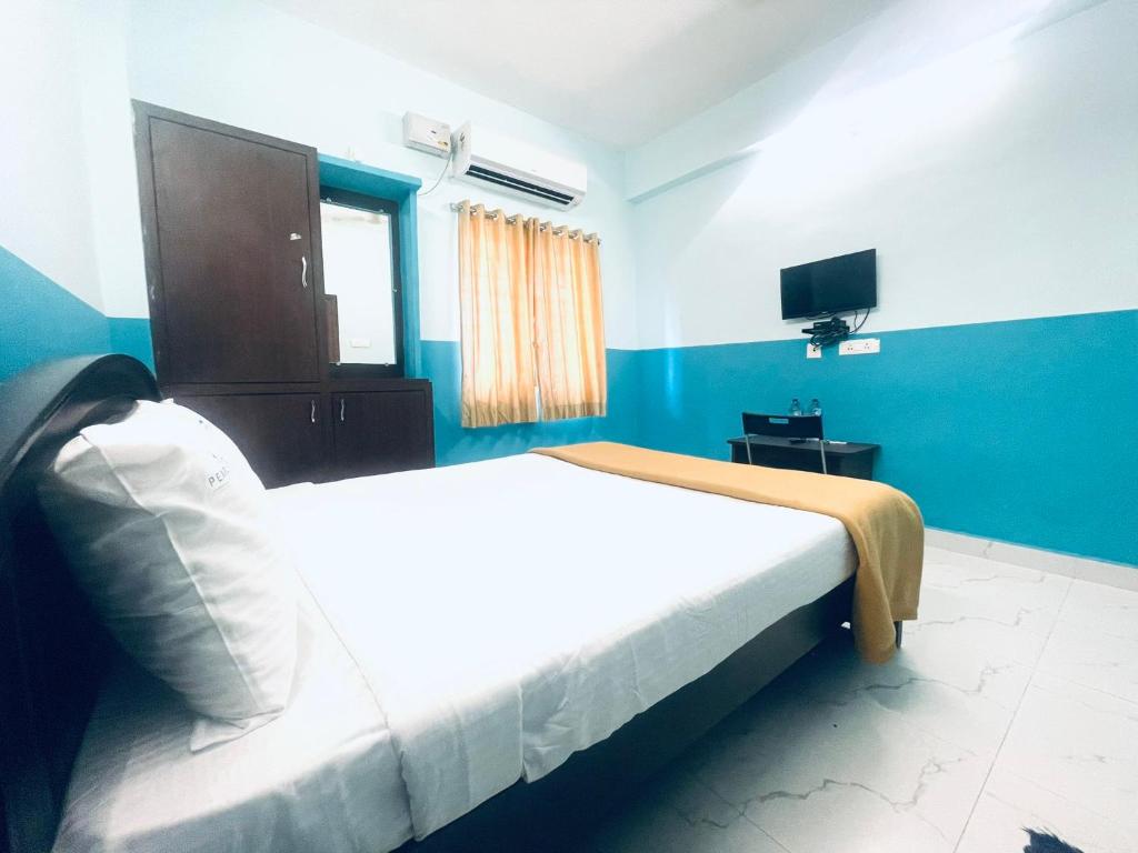 Postel nebo postele na pokoji v ubytování Hotel Deccan Park, Tirupati
