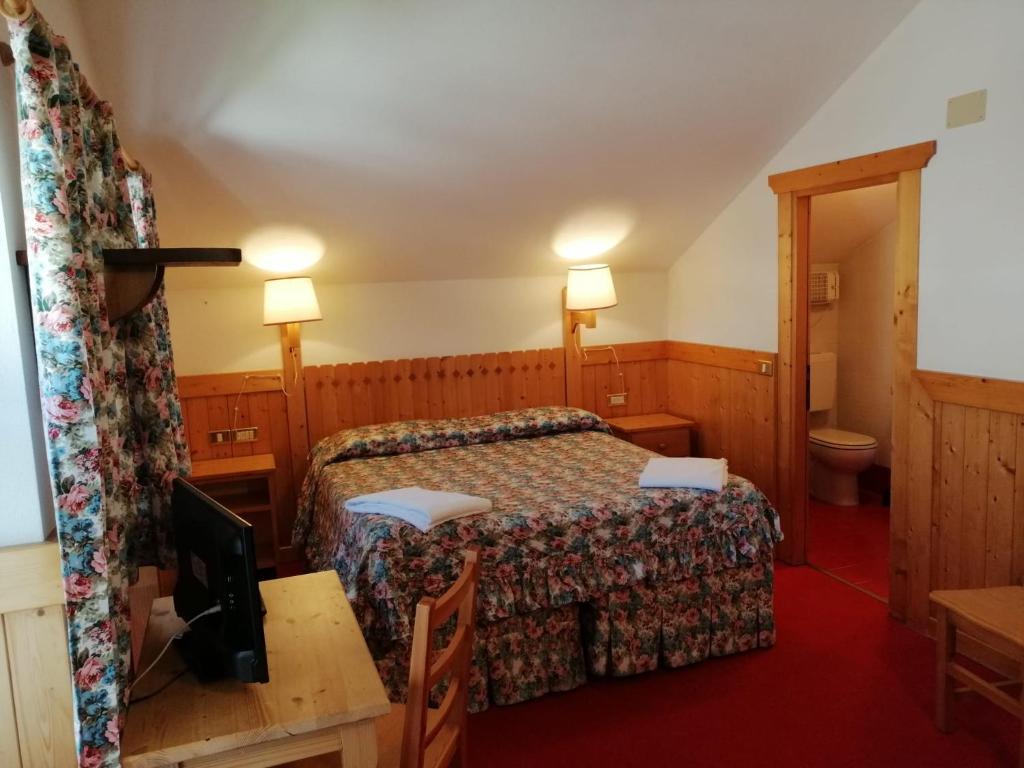 Postel nebo postele na pokoji v ubytování Hotel Locanda Grauson
