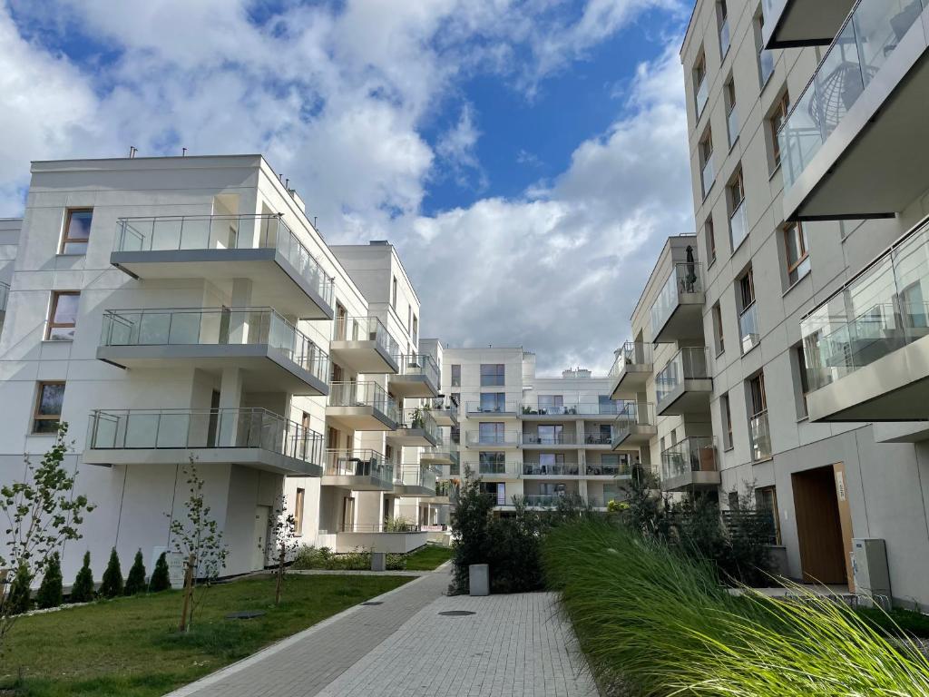 an apartment building with a walkway in front of it at Oaza Przystań in Giżycko