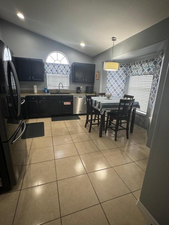 a kitchen and dining room with a table and chairs at Minnie Heaven in Kissimmee