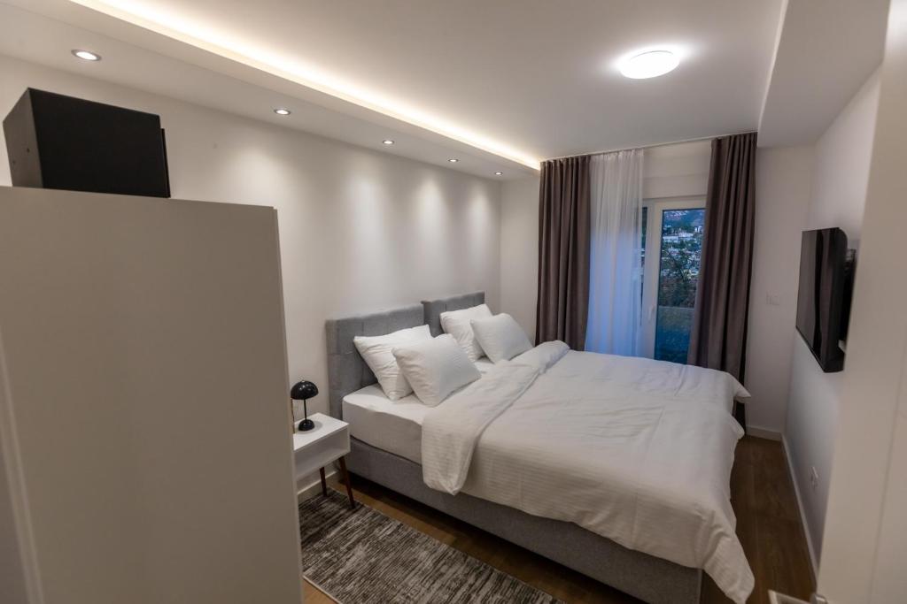 Postel nebo postele na pokoji v ubytování Apartmani Maira