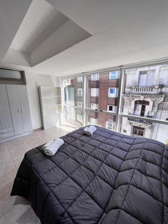 Postel nebo postele na pokoji v ubytování BORGES HOUSE APARTS Apartamentos con cochera a dos cuadras del Obelisco!