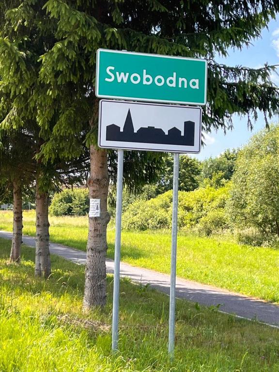 a street sign for swodonga on the side of a road at Leszczynowy domek nad jeziorem in Dobre Miasto
