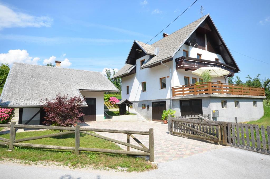 a large white house with a wooden fence at Anna's House in Bled