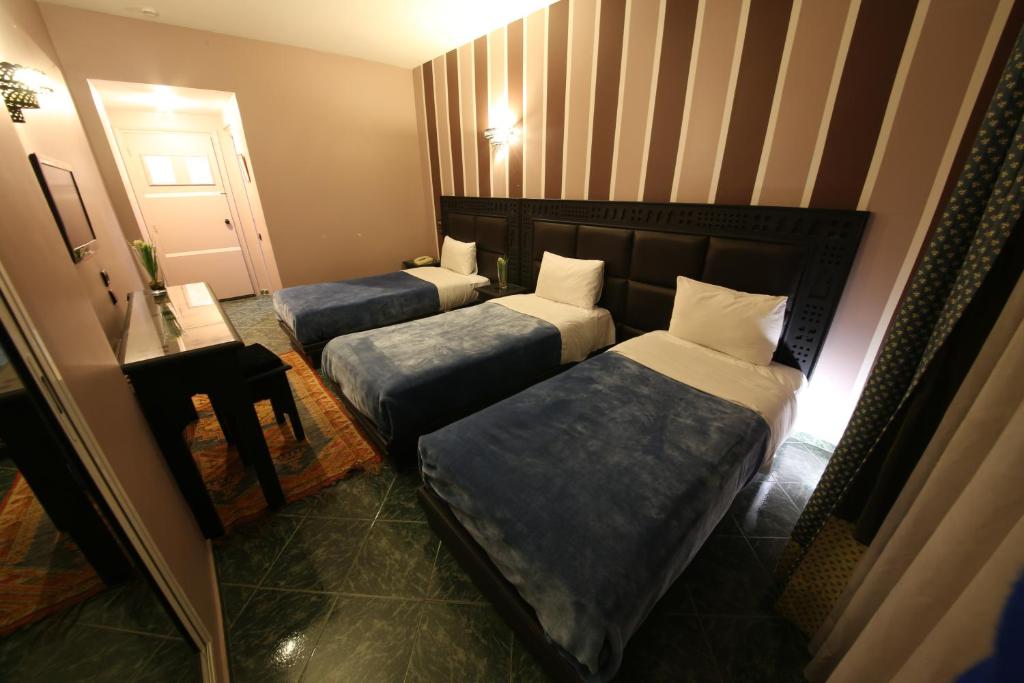Postel nebo postele na pokoji v ubytování Hotel Akouas