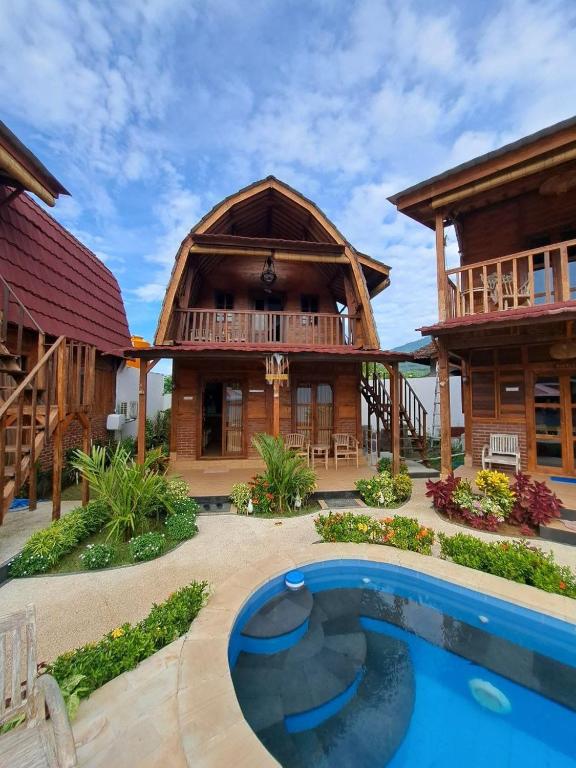 a resort with a pool in front of a building at Melasti Mountain Villas Amed in Amed
