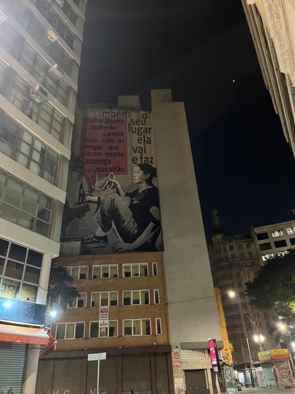 a building with a sign on the side of it at night at cara and toby in Sao Paulo