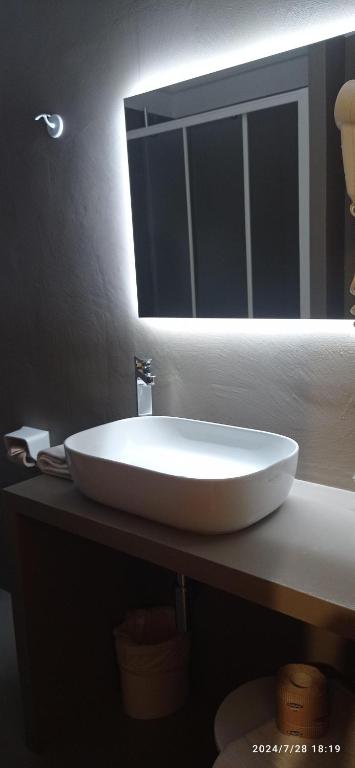 a white sink in a bathroom with a mirror at Hotel Calypso in Ventimiglia