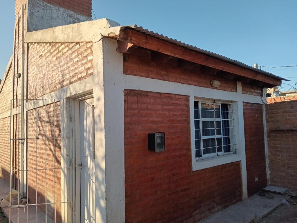 a brick building with a door and a window at Dpto en San Luis Capital in San Luis