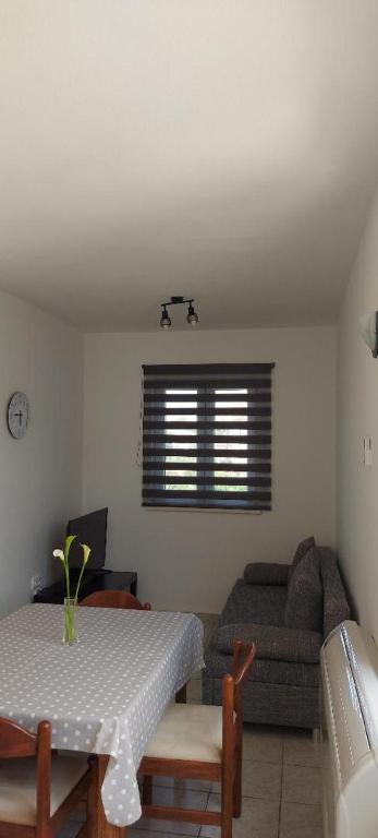 a living room with a table and a couch at Apartments Katica in Rab