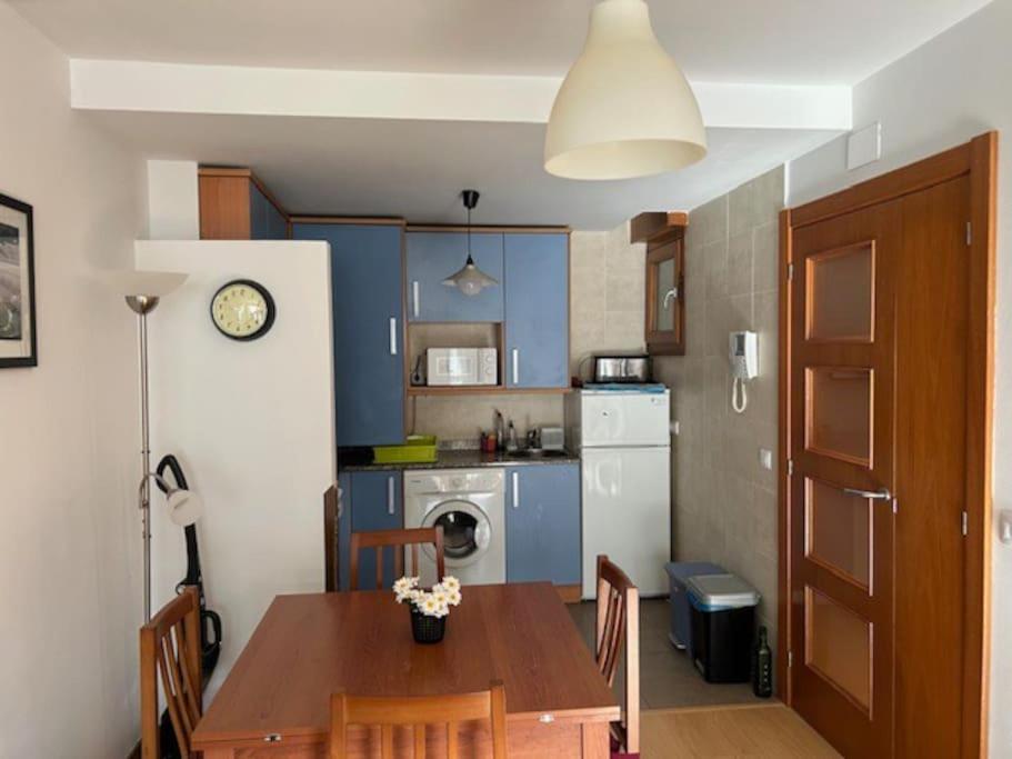 a kitchen with a wooden table and a kitchen with a dining room at Apartamento Playa de Barro in Barro de Llanes