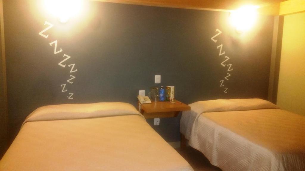 Postel nebo postele na pokoji v ubytování Hotel Plaza Queretaro
