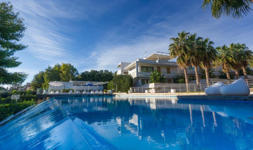 a large swimming pool in front of a house at Kamena Residence in Marina di Ragusa