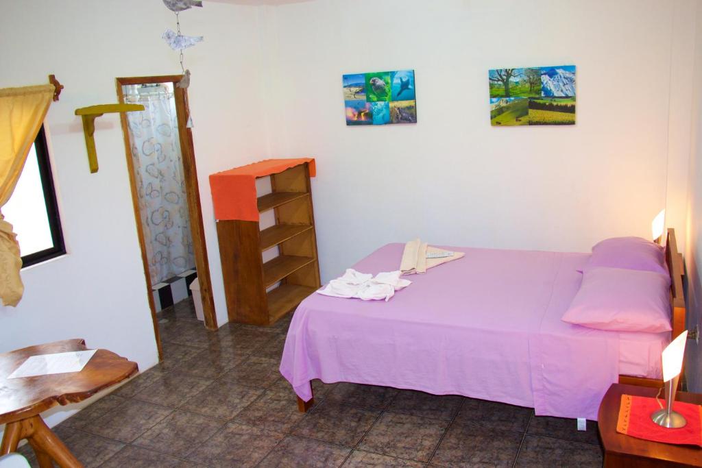 Postel nebo postele na pokoji v ubytování Hostal Suiza