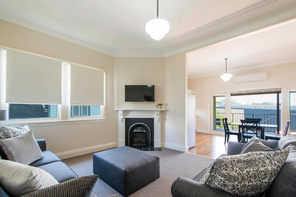 a living room with a couch and a fireplace at Victoria Street Apartments in Grafton
