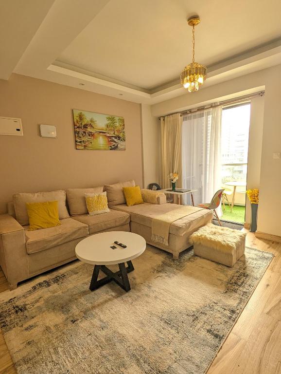 a living room with a couch and a table at Oakley Apartment- By Tito Homes in Nairobi