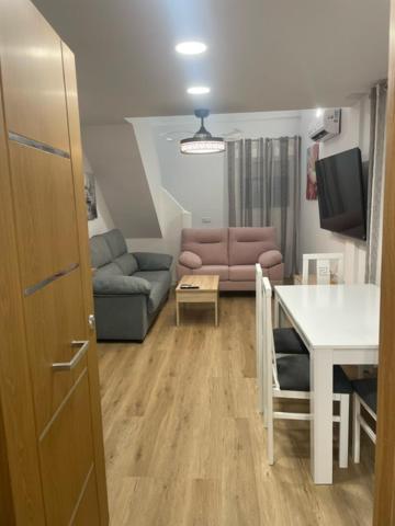 a living room with a couch and a table at Apartamentos ANDASOL in Chipiona